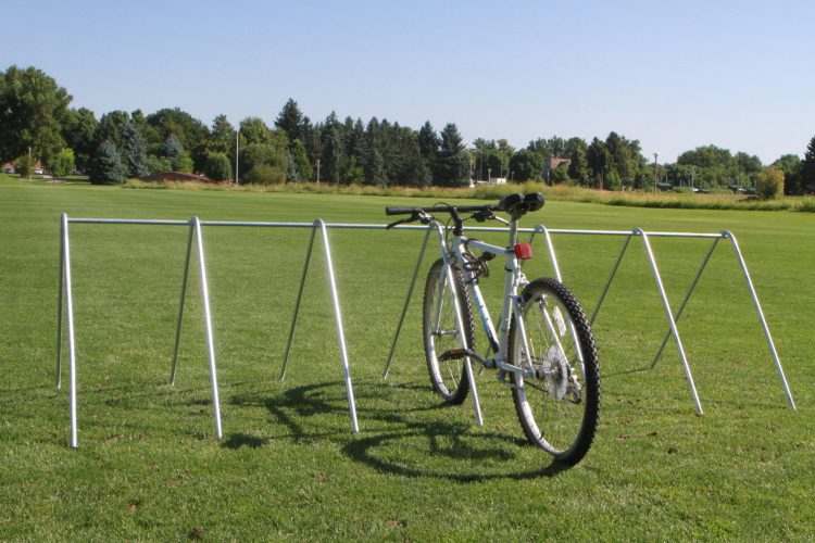 Stationary bike rack with example bike on grass